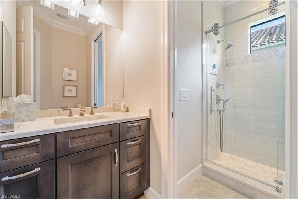 12130 Wicklow Lane Naples, FL 34120 - Photo 27 of 45 a bathroom with a sink and a mirror