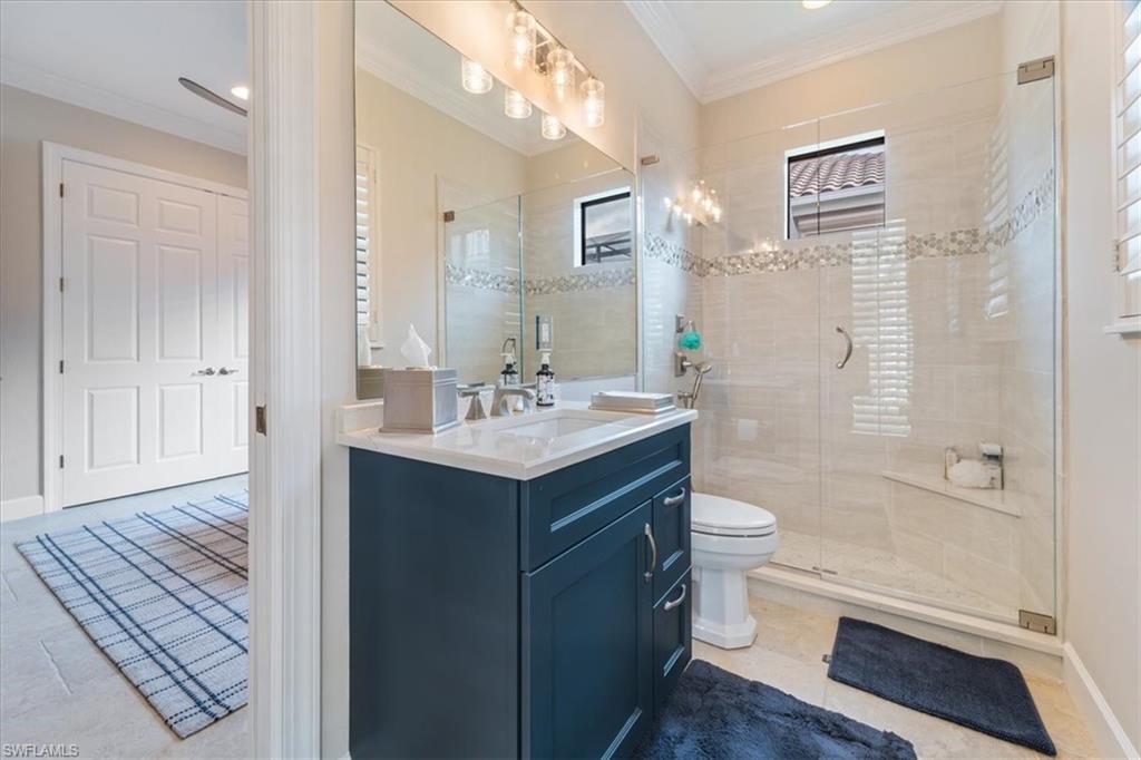 12130 Wicklow Lane Naples, FL 34120 - Photo 30 of 45 a bathroom with a sink a toilet and shower