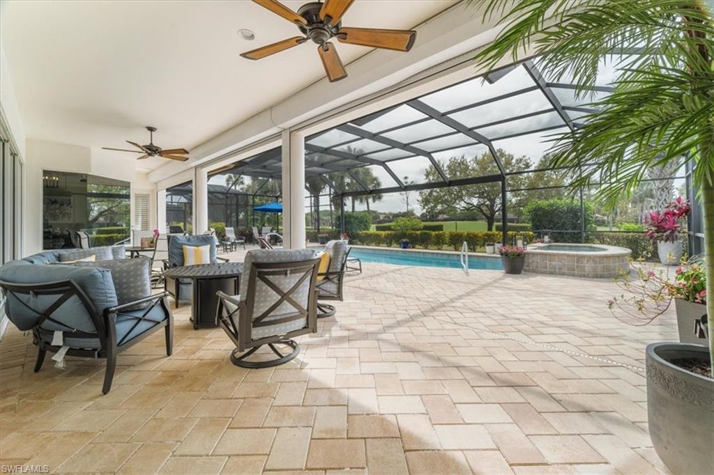 12130 Wicklow Lane Naples, FL 34120 - Photo 34 of 45 a view of a patio with a table and chairs