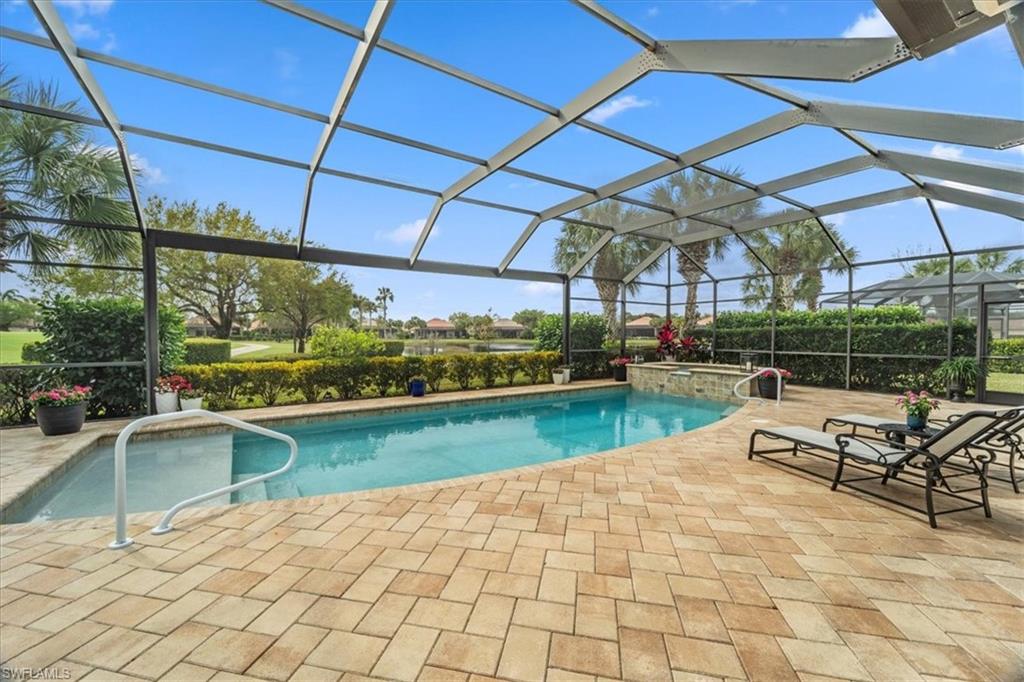 12130 Wicklow Lane Naples, FL 34120 - Photo 39 of 45 a view of a swimming pool with a patio