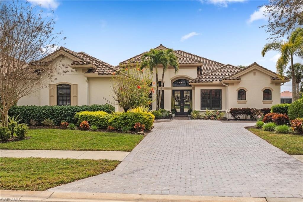 12130 Wicklow Lane Naples, FL 34120 - Photo 40 of 45 a front view of a house with a yard