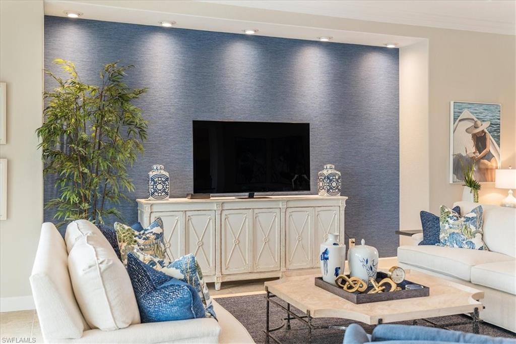 12130 Wicklow Lane Naples, FL 34120 - Photo 6 of 45 a living room with furniture and a flat screen tv