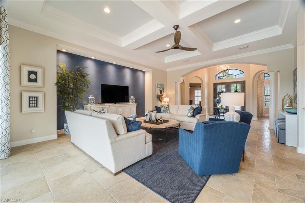 12130 Wicklow Lane Naples, FL 34120 - Photo 8 of 45 a living room with couches a flat screen tv and kitchen view