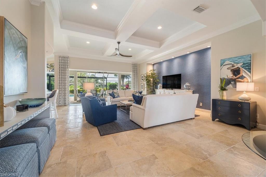 12130 Wicklow Lane Naples, FL 34120 - Photo 9 of 45 a living room with furniture and a flat screen tv