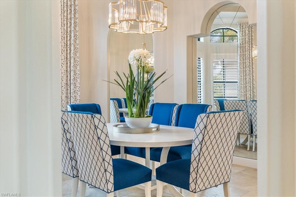 12130 Wicklow Lane Naples, FL 34120 - Photo 10 of 45 a view of a dining room with furniture window and wooden floor