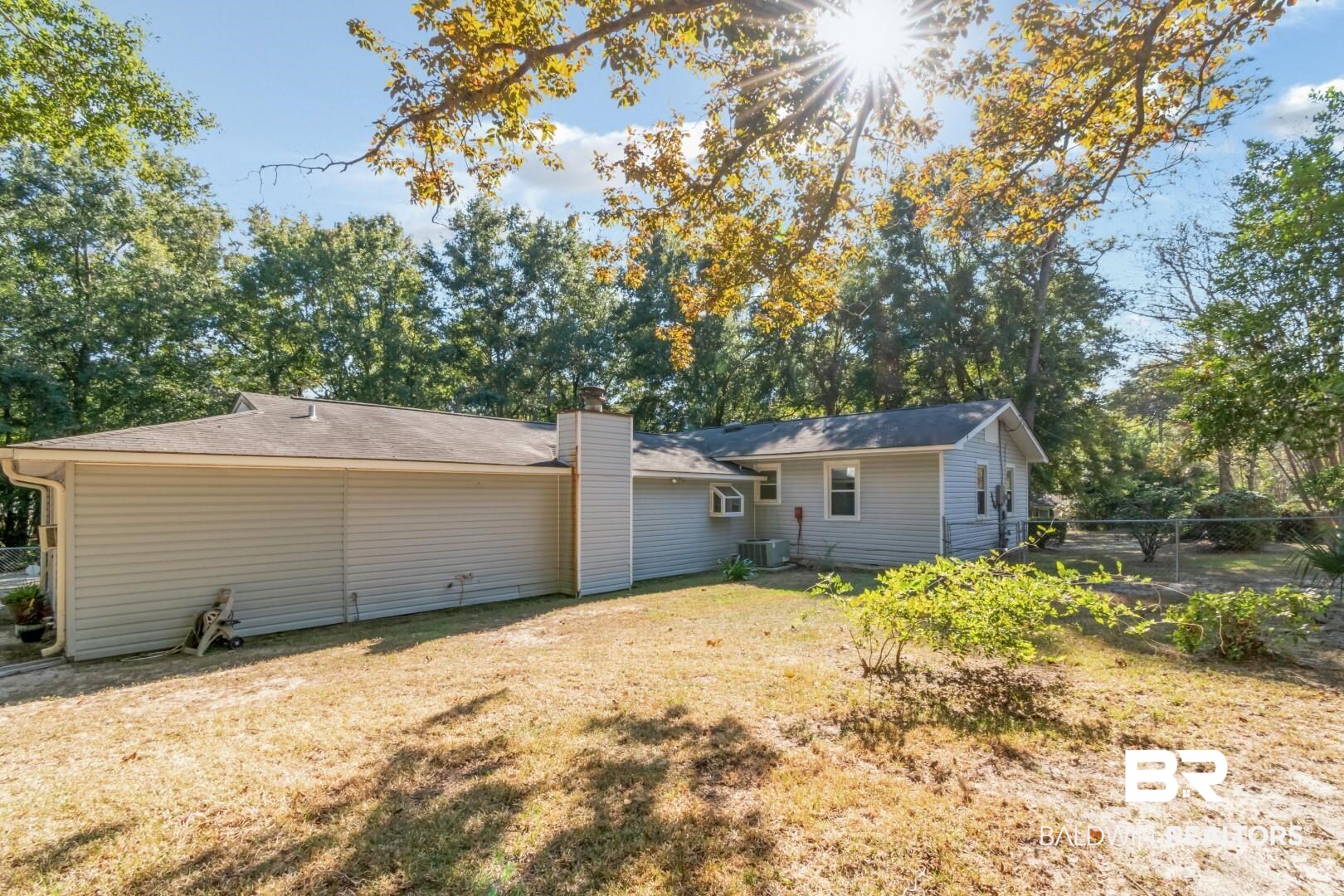 1321 Rainbow Drive West Mobile, AL 36693 - Photo 40 of 48 Rear view of property with central AC and a yard