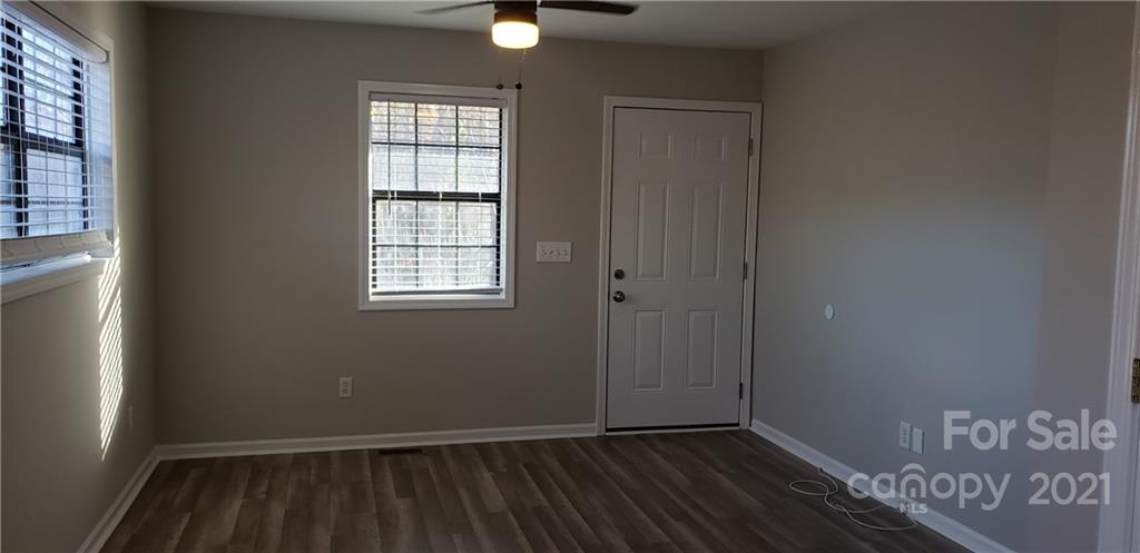 4380 Cannery Road Lancaster, SC 29720 - Photo 2 of 8 an empty room with wooden floor cabinet and windows