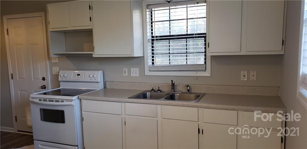4380 Cannery Road Lancaster, SC 29720 - Photo 4 of 8 a kitchen with granite countertop a sink a stove and cabinets