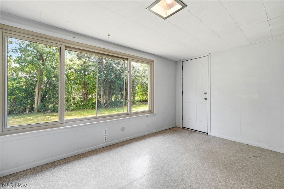2537 Edgewood Road Beachwood, OH 44122 - Photo 23 of 39 Room featuring a wall of multiple windows, a paneled door, and a textured ceiling