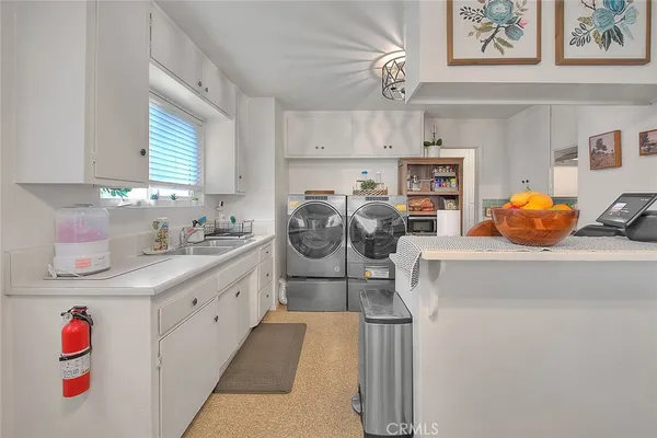 a kitchen with stainless steel appliances granite countertop a refrigerator and a dining table
