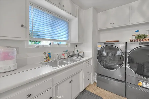 a bedroom with bed and a chandelier