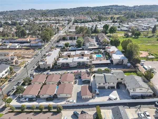 an aerial view of a residential houses with city view