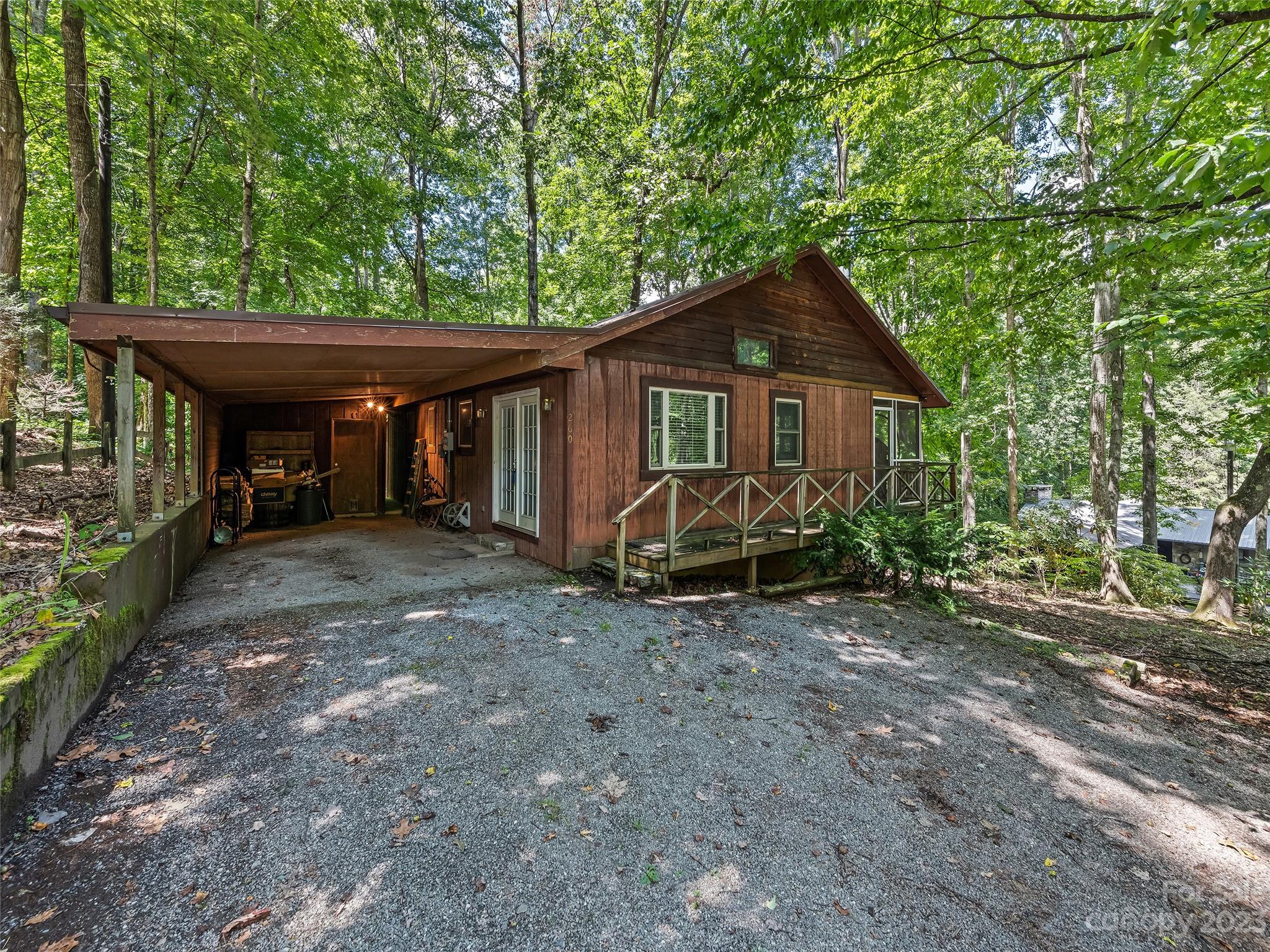260 Reuben Branch Road Maggie Valley, NC 28751 - Photo 1 of 24 a view of a house with a yard and large trees