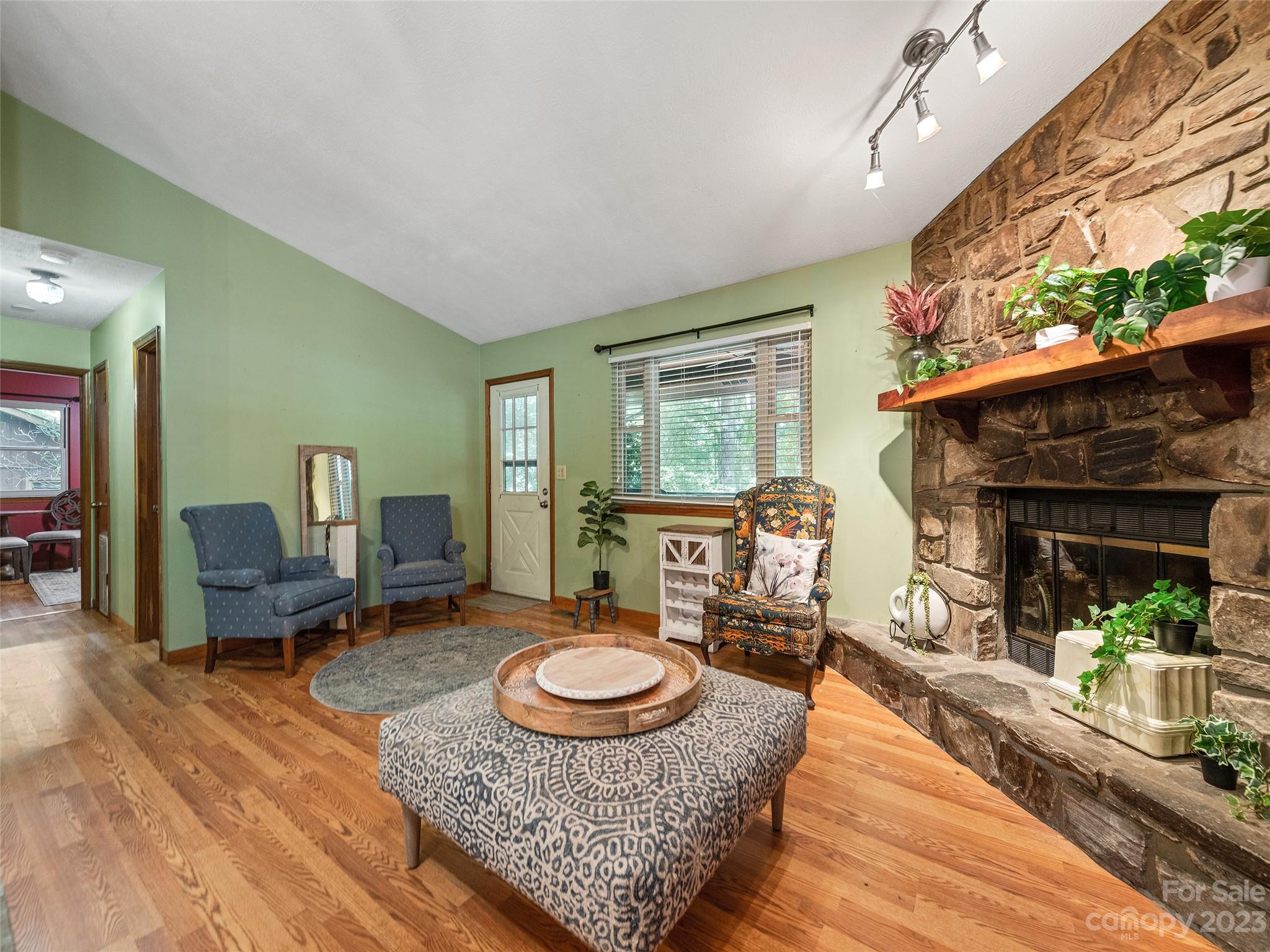 260 Reuben Branch Road Maggie Valley, NC 28751 - Photo 11 of 24 a living room with furniture and a fireplace