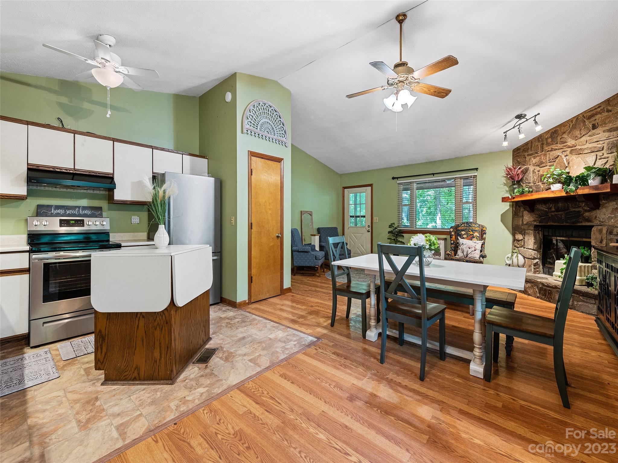 260 Reuben Branch Road Maggie Valley, NC 28751 - Photo 16 of 24 a living room with furniture a fireplace and a dining table