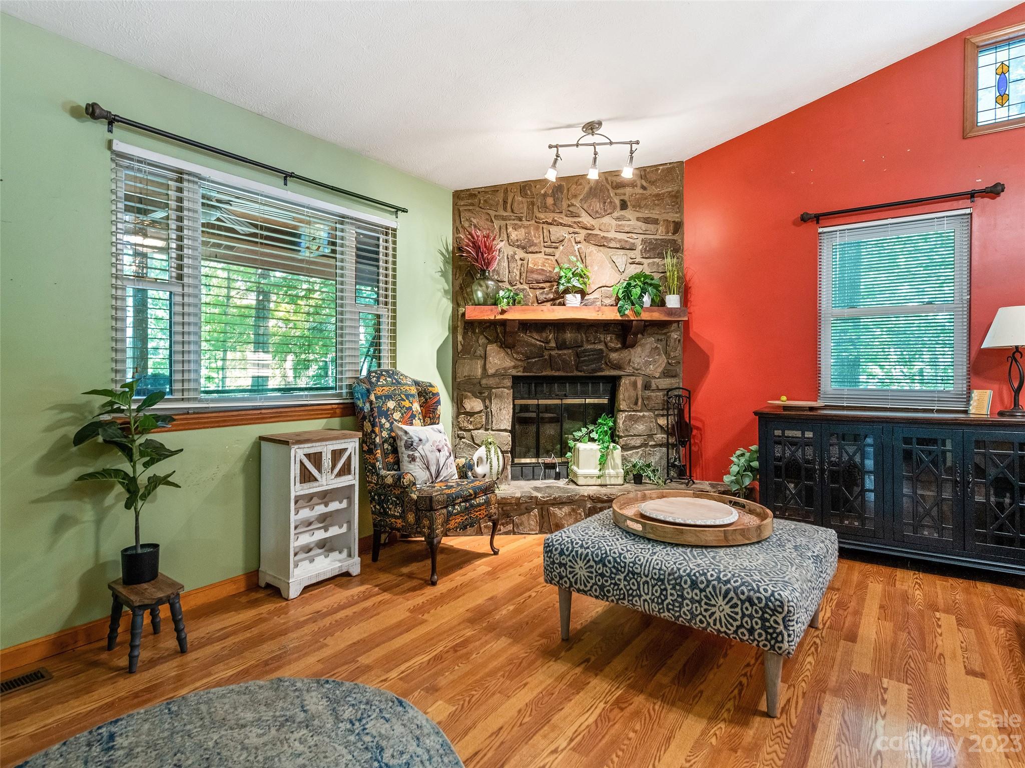 260 Reuben Branch Road Maggie Valley, NC 28751 - Photo 10 of 24 a living room with furniture a fireplace a rug and a window