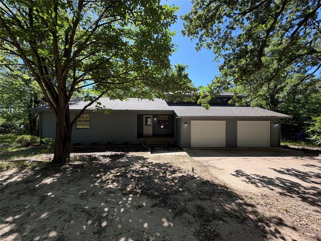 257 West Acres Road Gun Barrel City, TX 75156 - Photo 1 of 22 a house with trees in front of it