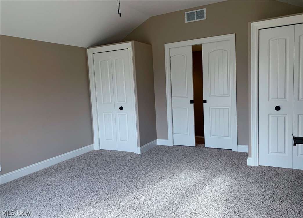 819 Brook Road Wadsworth, OH 44281 - Photo 23 of 35 Raised bedroom with vaulted ceiling and sliding pocket door entrance flanked by two closets.
