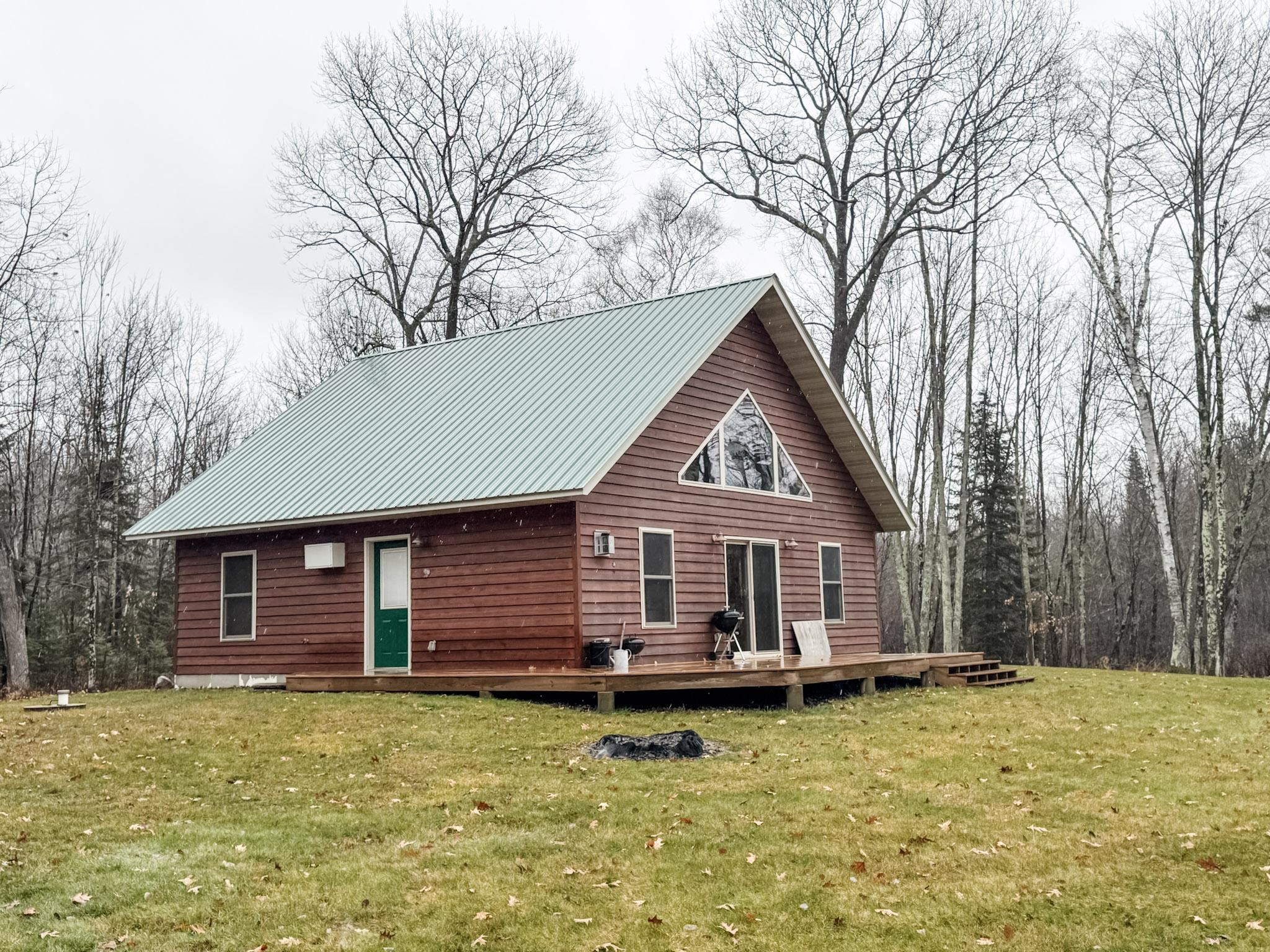 11466 Westerlund Loop Solon Springs, WI 54873 - Photo 1 of 55 Rear view of house featuring a yard, a metal roof, and a wooden deck