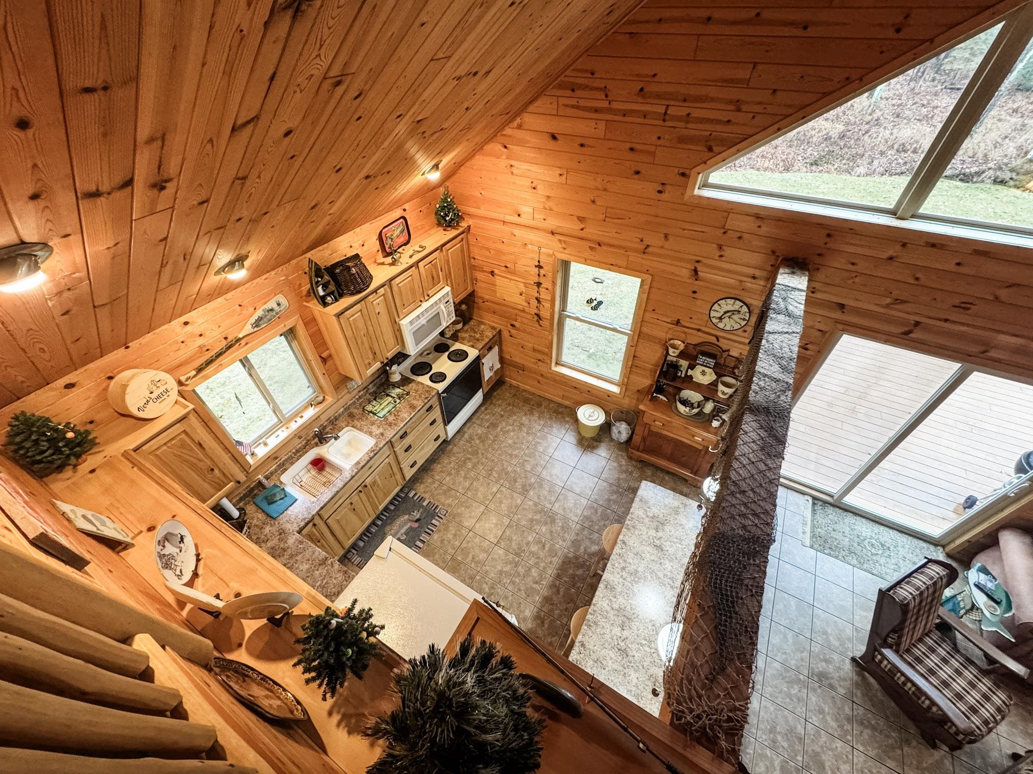 11466 Westerlund Loop Solon Springs, WI 54873 - Photo 19 of 55 Living area featuring wood walls, wooden ceiling, and high vaulted ceiling