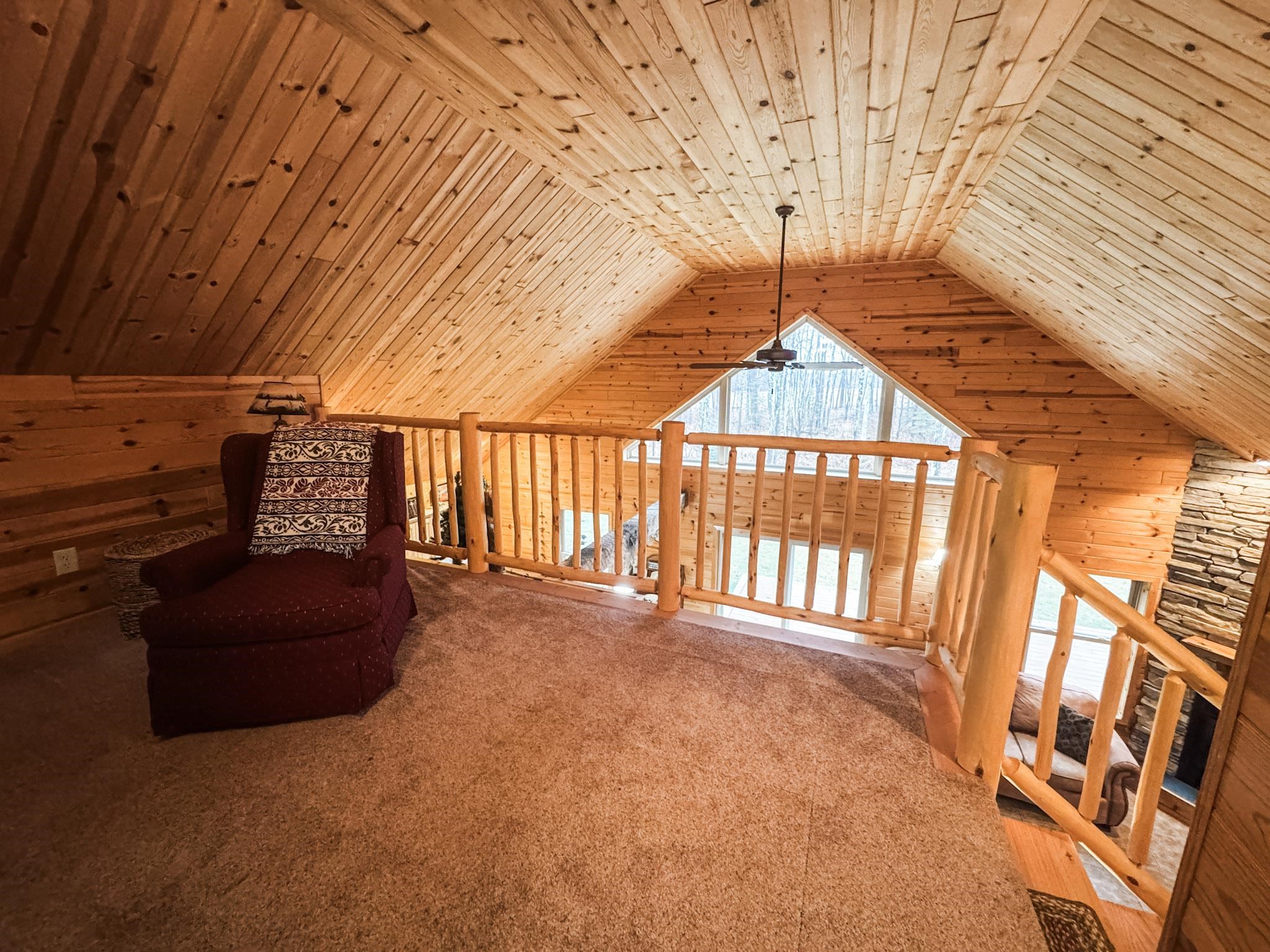 11466 Westerlund Loop Solon Springs, WI 54873 - Photo 22 of 55 Unfurnished room featuring wooden walls, wooden ceiling, vaulted ceiling, carpet floors, and a ceiling fan