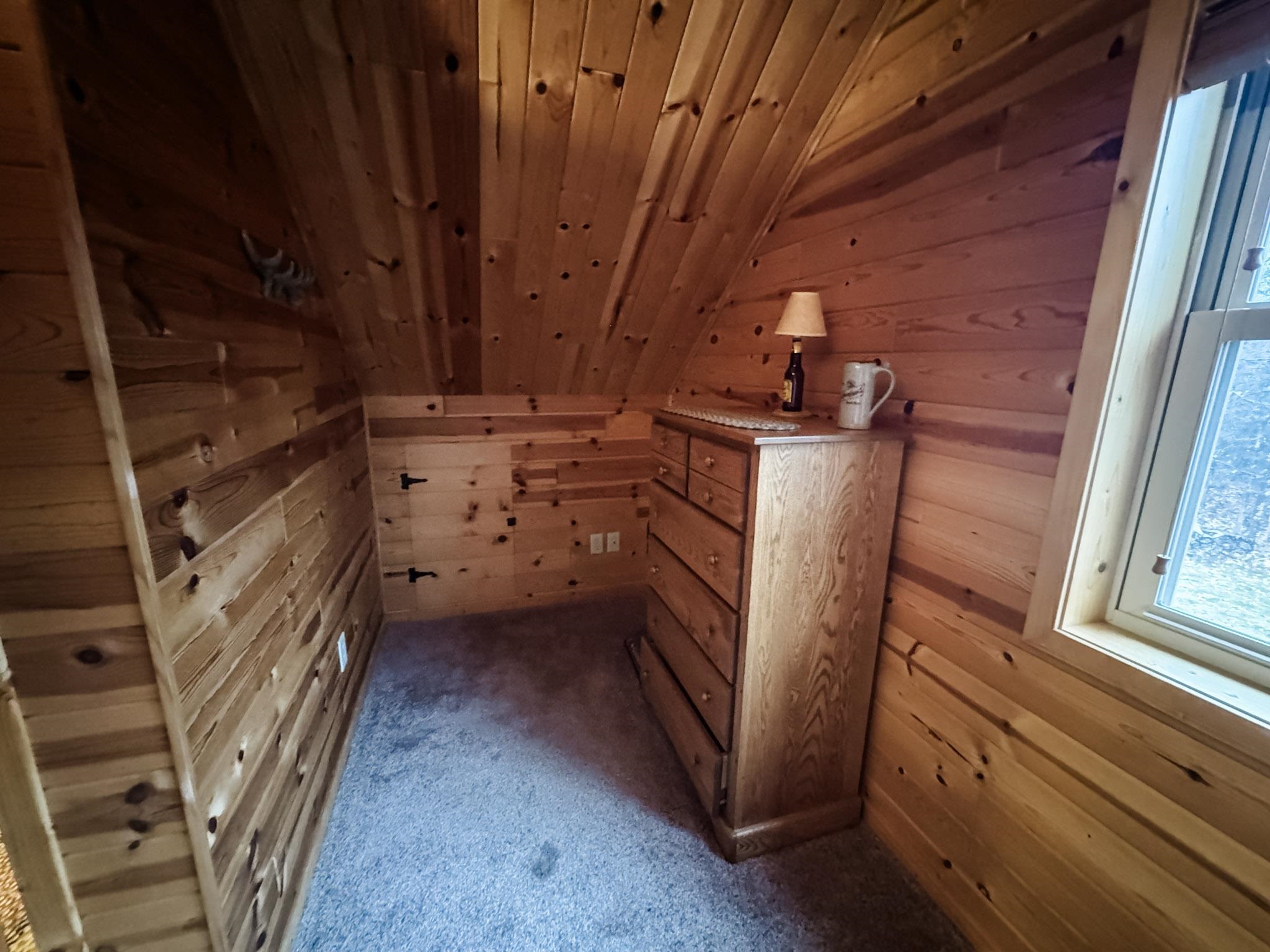 11466 Westerlund Loop Solon Springs, WI 54873 - Photo 24 of 55 Additional living space with wooden walls, wood ceiling, lofted ceiling, and carpet