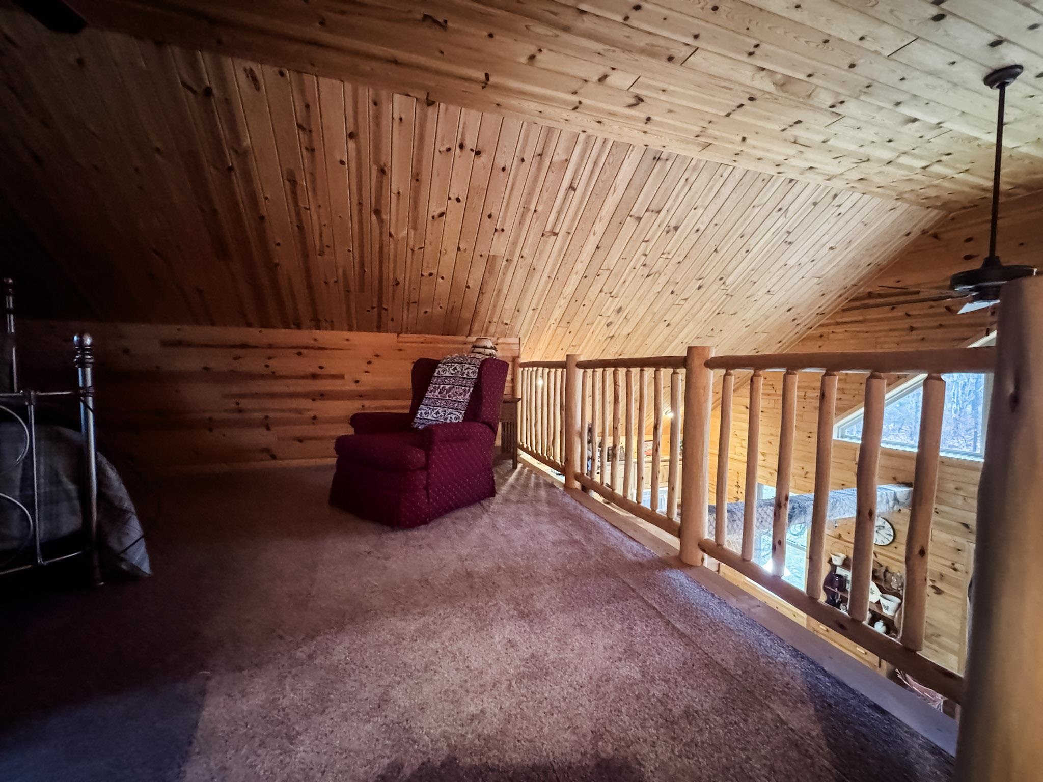 11466 Westerlund Loop Solon Springs, WI 54873 - Photo 31 of 55 Unfurnished room with wooden ceiling, carpet, and wooden walls