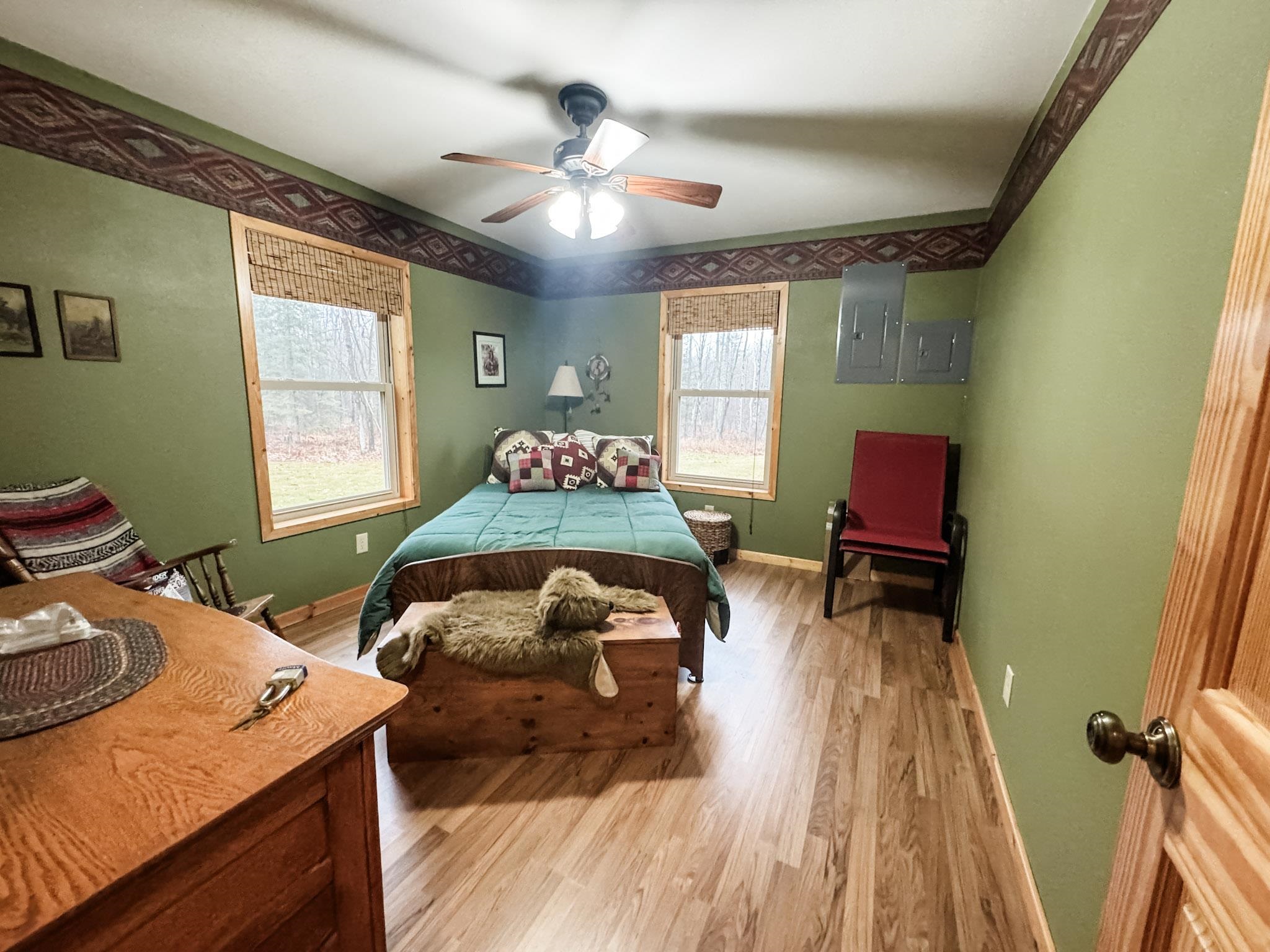 11466 Westerlund Loop Solon Springs, WI 54873 - Photo 35 of 55 Bedroom with electric panel, a ceiling fan, and light wood finished floors