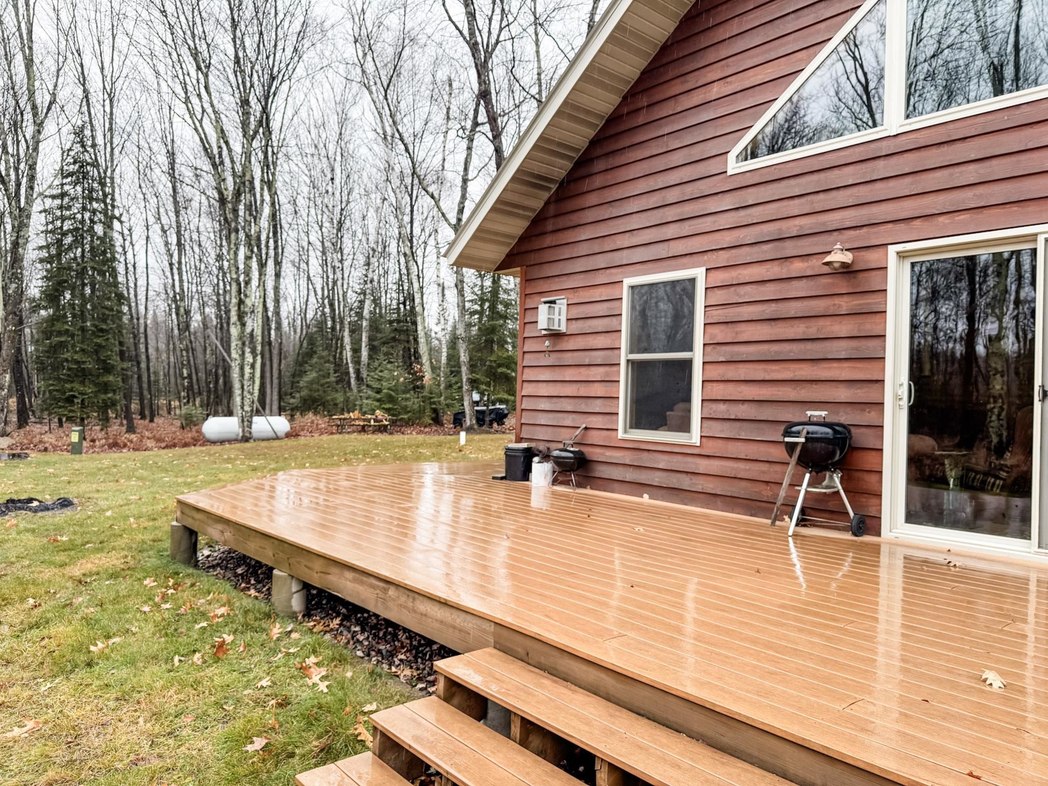 11466 Westerlund Loop Solon Springs, WI 54873 - Photo 43 of 55 Wooden terrace featuring a lawn