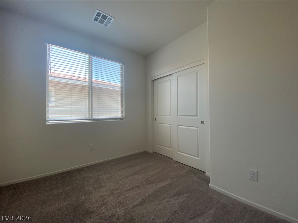 436 Cadence View Way Henderson, NV 89011 - Photo 22 of 36 Well-lit and ready for personalization, this bedroom features soft carpet and a convenient closet.