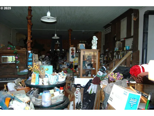 a group of people sitting in front of retail shop