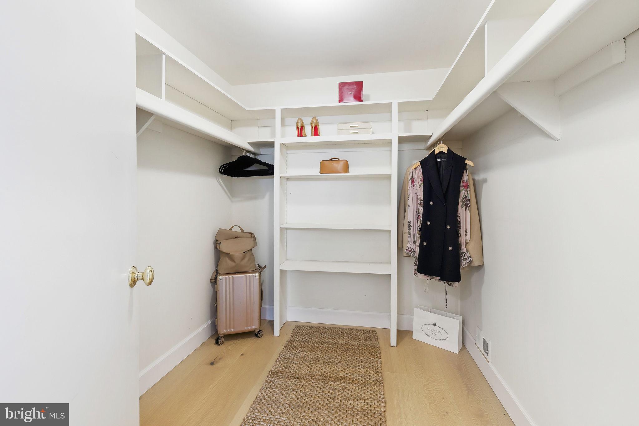 10900 Gainsborough Road Potomac, MD 20854 - Photo 29 of 44 a view of walk in closet with clothes and shoes