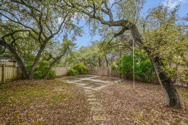 a view of a house with a tree in the yard