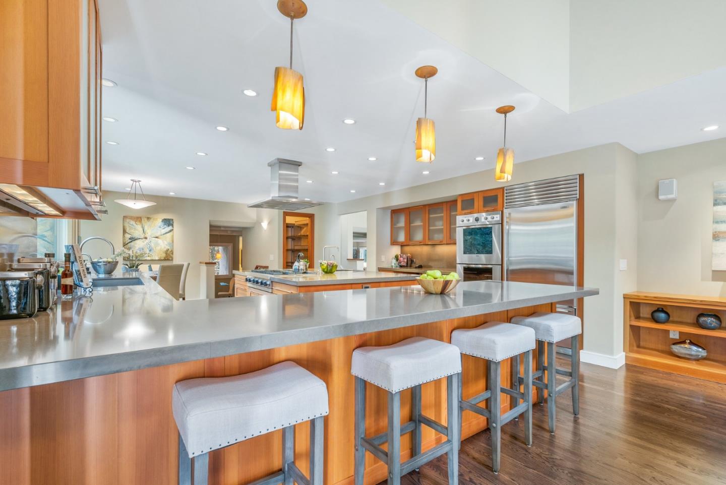 500 Bear Valley Road Aptos, CA 95003 - Photo 32 of 91 a kitchen with stainless steel appliances granite countertop a stove top oven a dining table and chairs with wooden floor