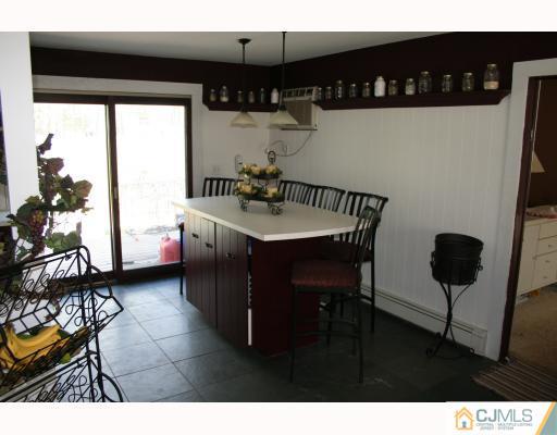 12 Baldwin Road Edison, NJ 08817 - Photo 4 of 10 a dining room with furniture and a kitchen view