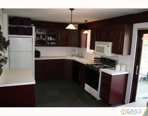 12 Baldwin Road Edison, NJ 08817 - Photo 5 of 10 a kitchen with stainless steel appliances a sink stove and refrigerator