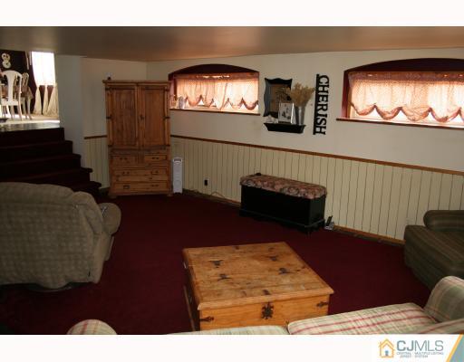 12 Baldwin Road Edison, NJ 08817 - Photo 7 of 10 a living room with furniture and a flat screen tv