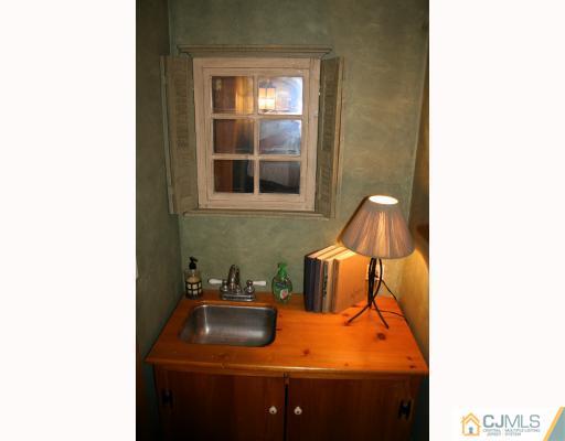 12 Baldwin Road Edison, NJ 08817 - Photo 8 of 10 a bathroom with a sink and a mirror