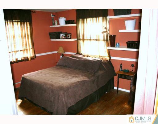 12 Baldwin Road Edison, NJ 08817 - Photo 9 of 10 a bed sitting in a bedroom next to a window