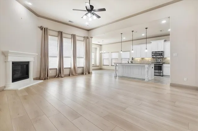 an empty room with fan and a ceiling fan