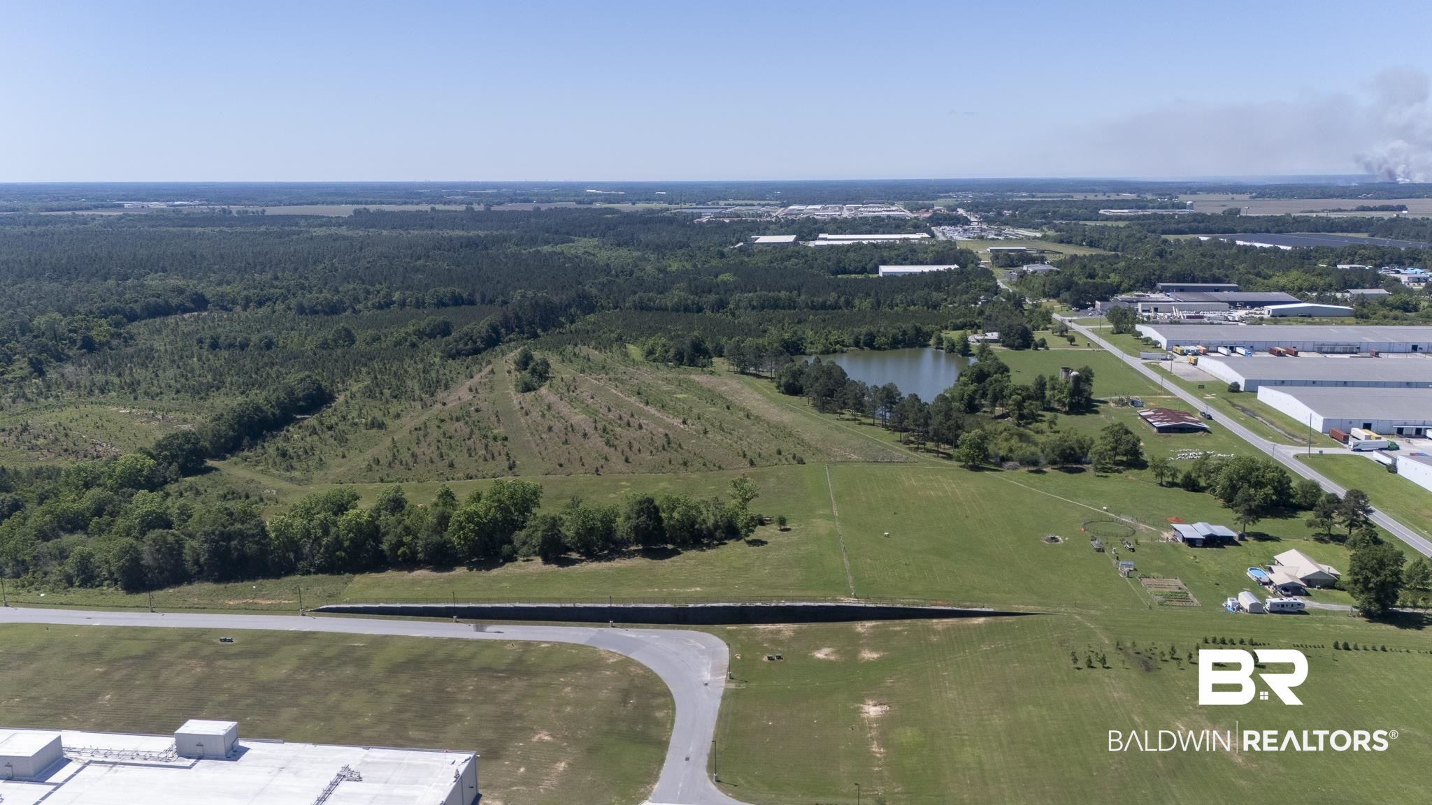 30580 County Road 49 Loxley, AL 36551 - Photo 6 of 32 Expansive aerial landscape featuring a large body of water, extensive tree coverage, and open green spaces