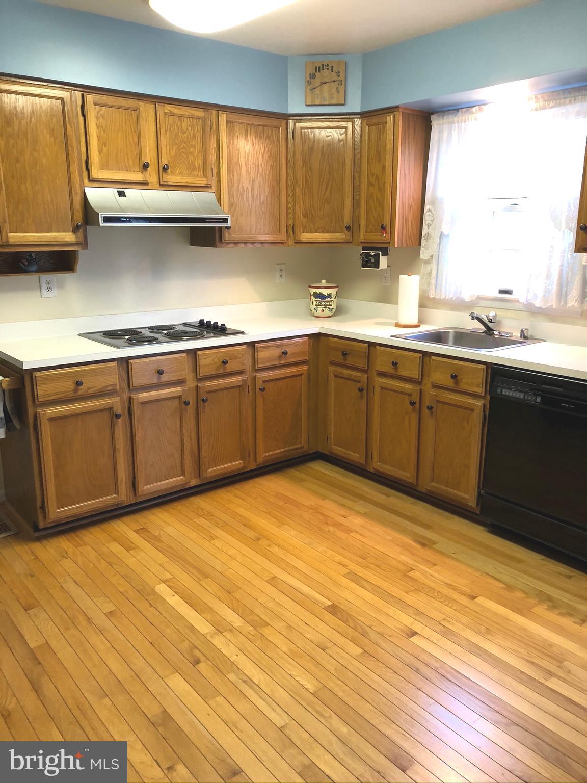 9513 Stoneoak Road Baltimore, MD 21236 - Photo 8 of 36 a kitchen with stainless steel appliances granite countertop a sink cabinets and wooden floor