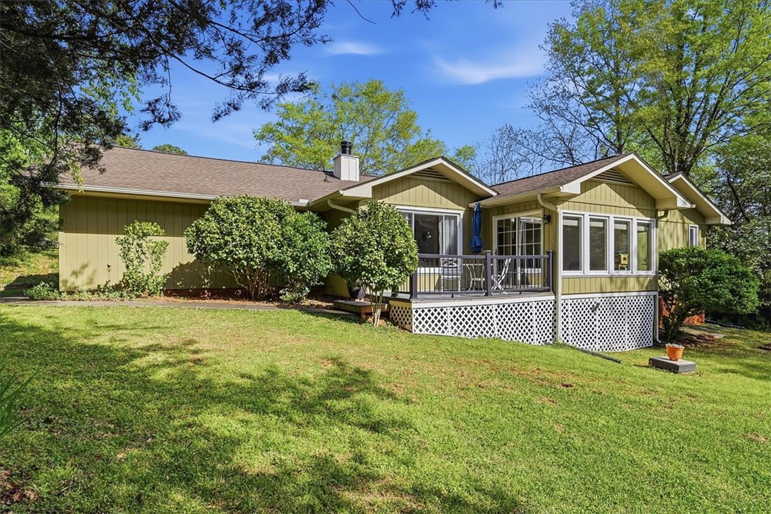 729 State Rd S-37-359 Seneca, SC 29672 - Photo 28 of 35 This charming home offers a spacious deck and lush green surroundings for comfortable outdoor living.