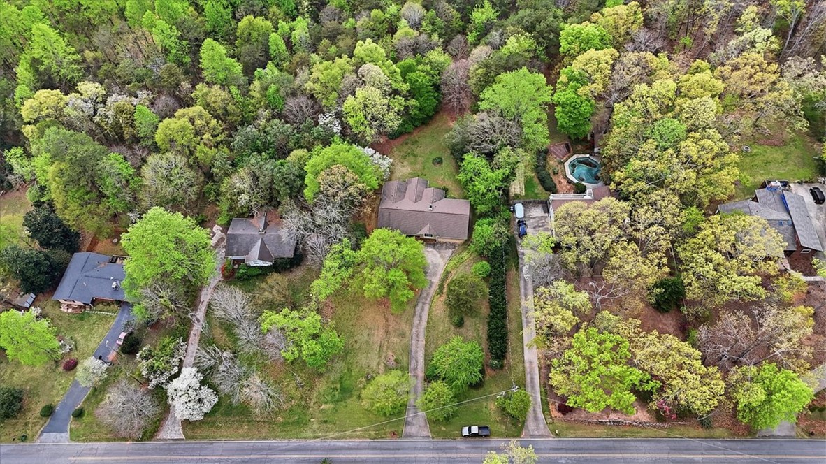 729 State Rd S-37-359 Seneca, SC 29672 - Photo 31 of 35 This verdant aerial view showcases a property nestled among lush trees, featuring a serene private pool.