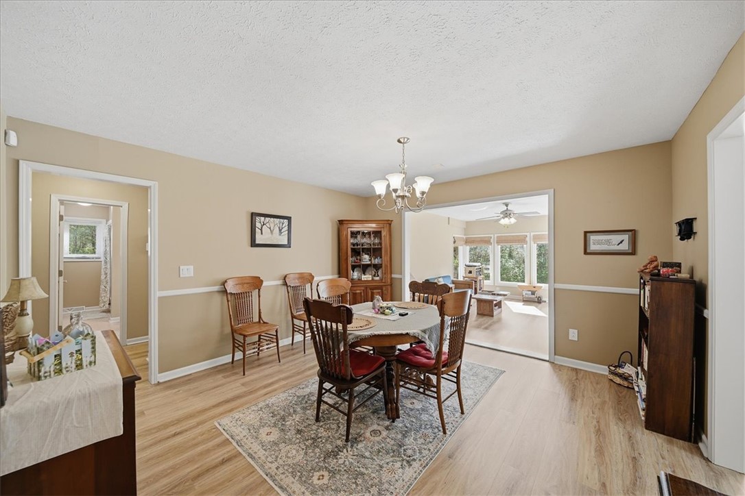 729 State Rd S-37-359 Seneca, SC 29672 - Photo 8 of 35 This inviting dining area features elegant flooring, an overhead light, and seamlessly connects to a bright living space.