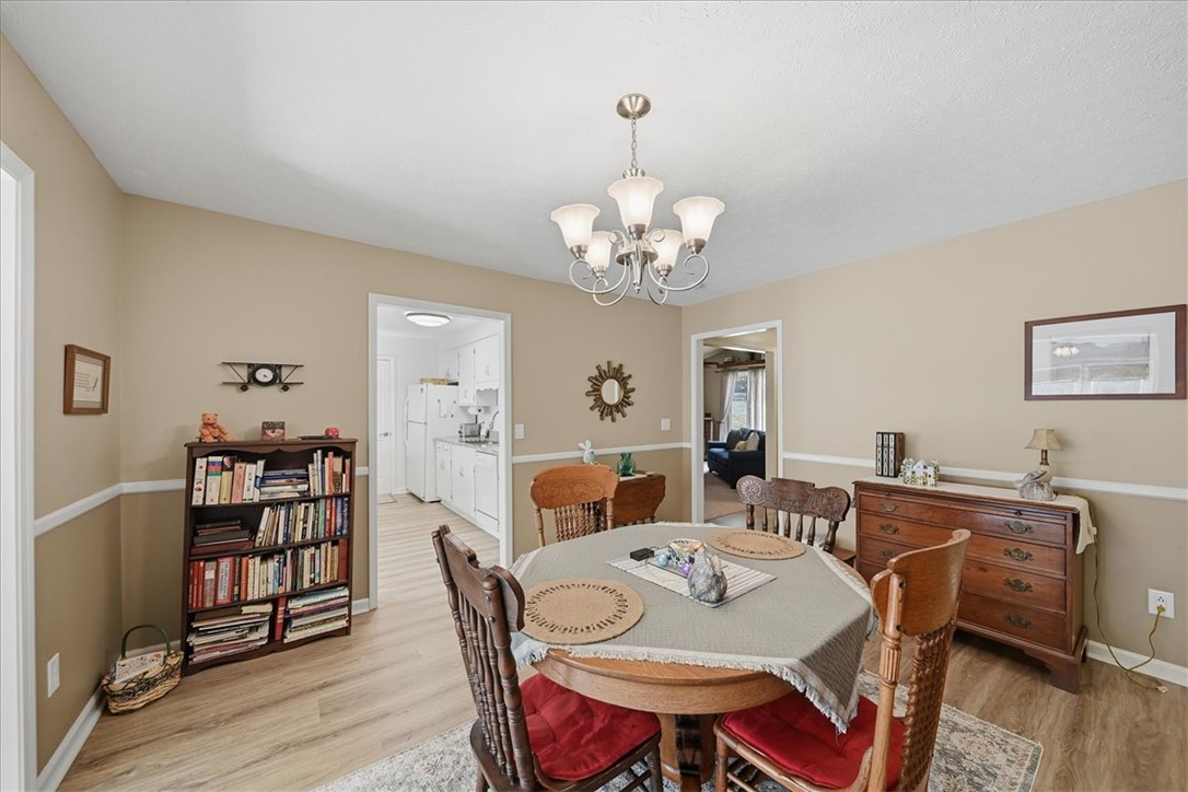 729 State Rd S-37-359 Seneca, SC 29672 - Photo 9 of 35 This inviting dining area features elegant flooring and a lovely chandelier.