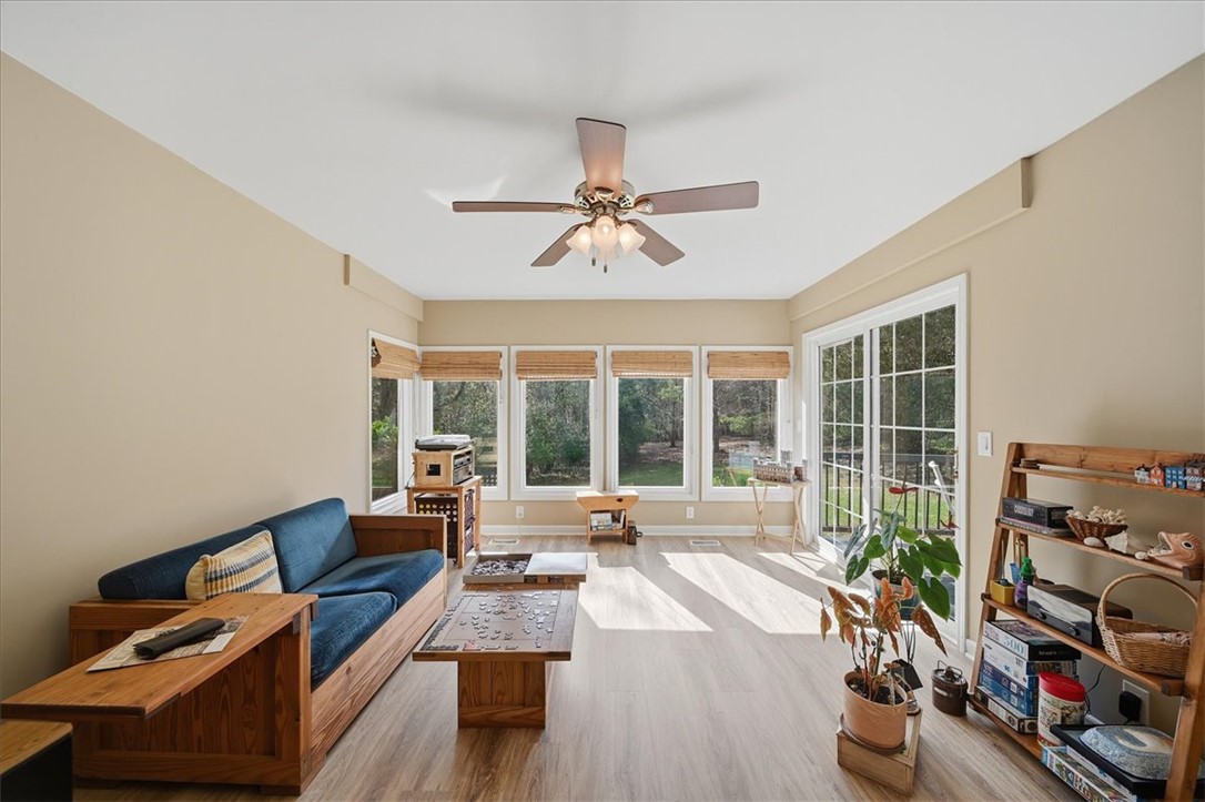 729 State Rd S-37-359 Seneca, SC 29672 - Photo 10 of 35 This living room features expansive windows that invite abundant natural light and offer serene outdoor views.