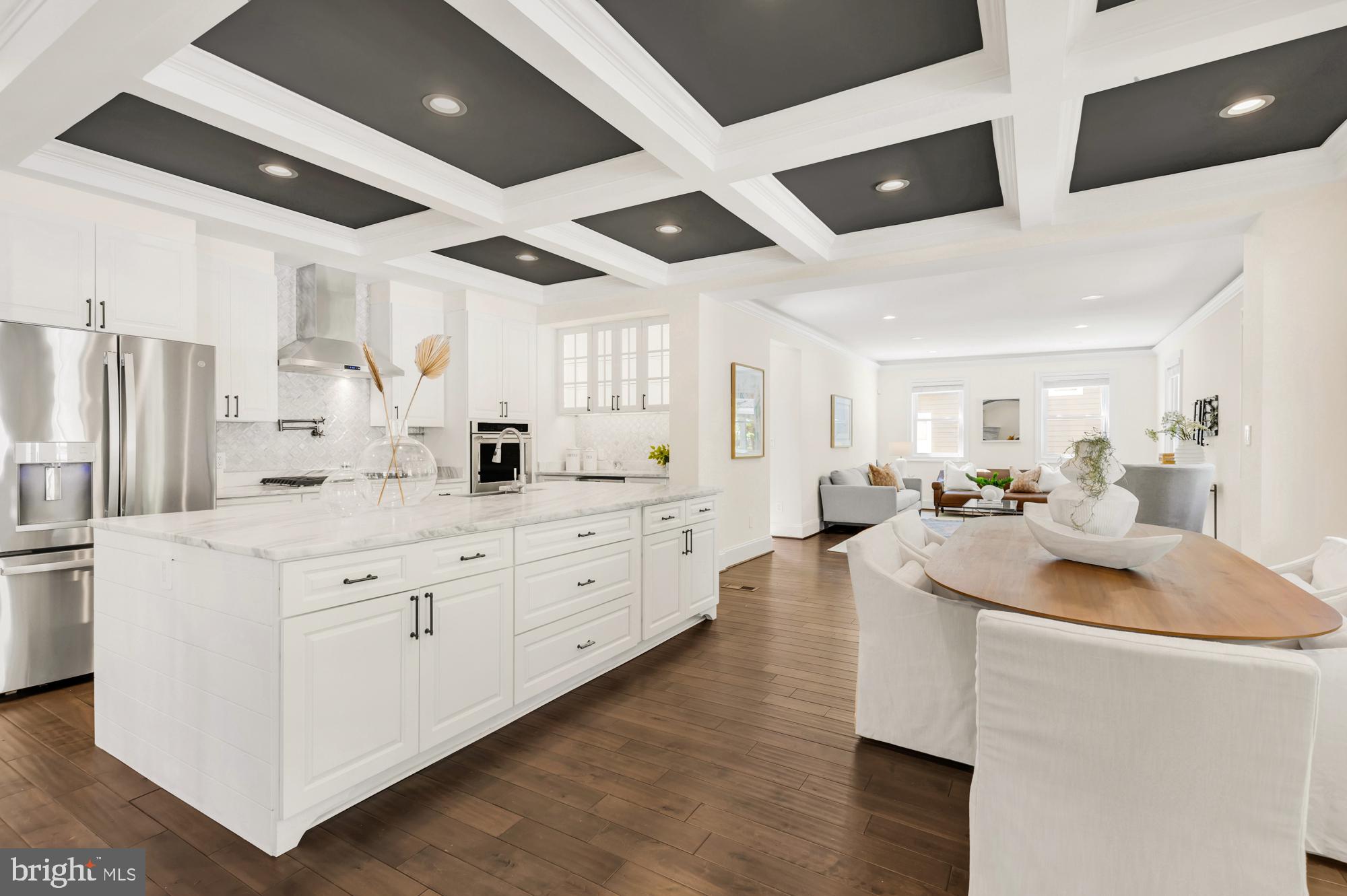 1202 Decatur Street Northwest Washington, DC 20011 - Photo 14 of 53 a kitchen with stainless steel appliances kitchen island granite countertop a sink a stove and a refrigerator