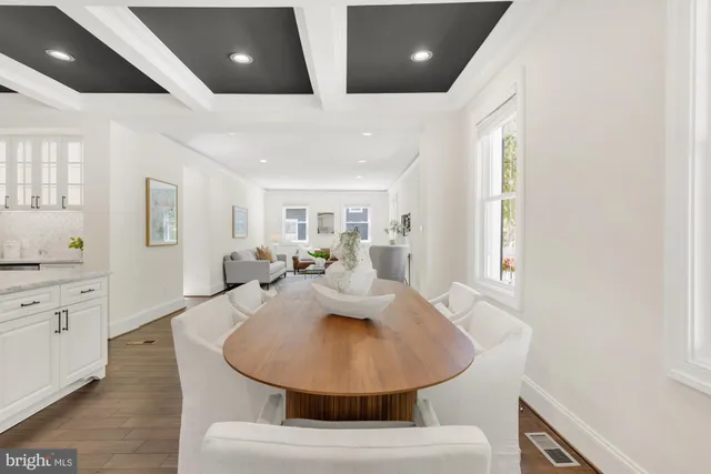 a kitchen with stainless steel appliances kitchen island granite countertop a refrigerator and a sink