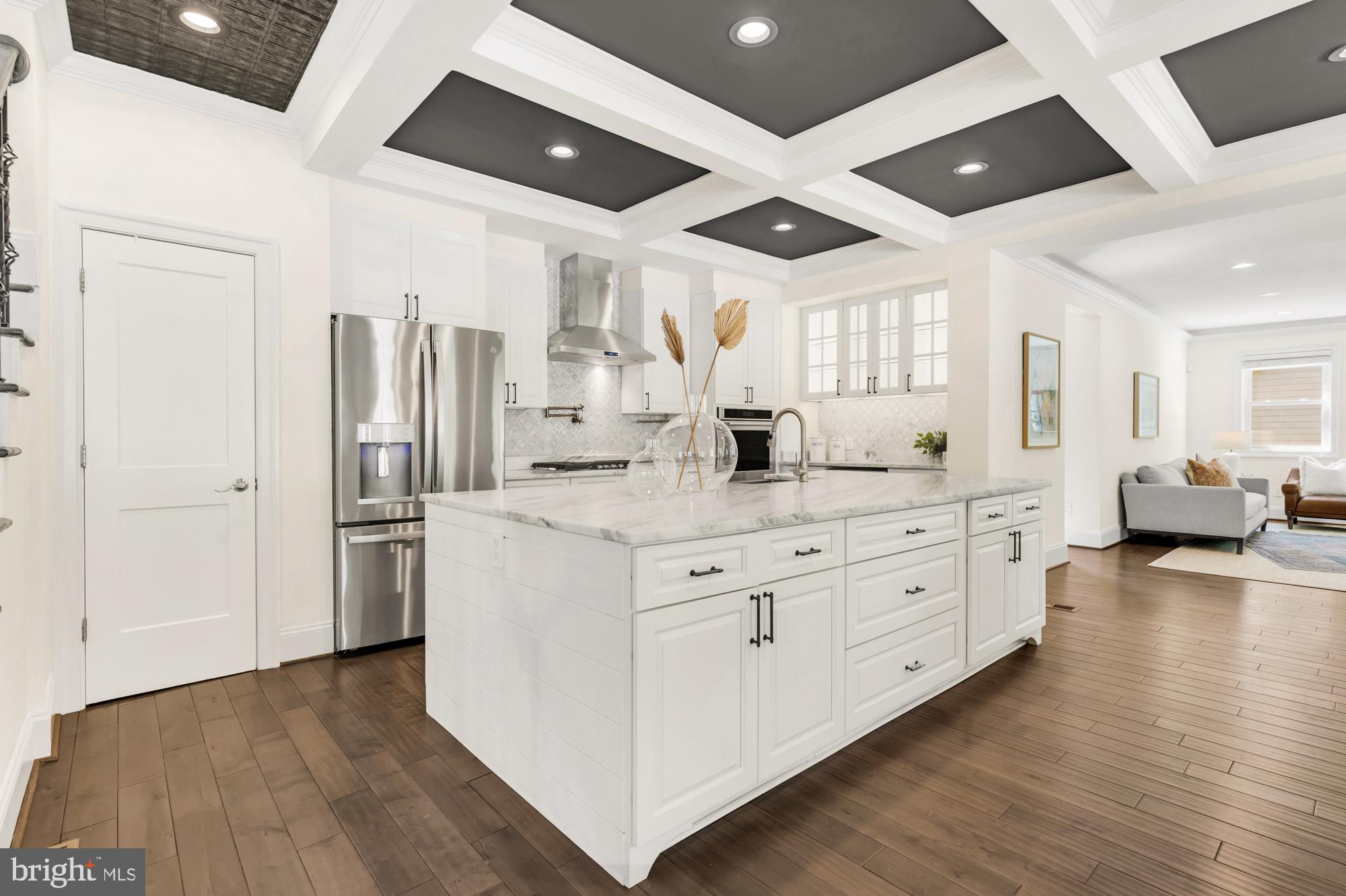 1202 Decatur Street Northwest Washington, DC 20011 - Photo 16 of 53 a kitchen with stainless steel appliances kitchen island granite countertop a refrigerator and a sink